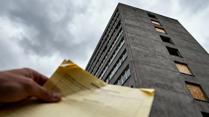 Vernagelte Fenster an Bürogebäude symbolisieren Risiken bei geschlossenen Immobilienfonds und Leerstand